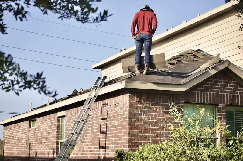 Professional roofer working on a residential roof in Forest Hills Estates